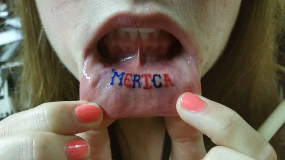 Red and blue lettering spells 'MERICA inside the lower lip.