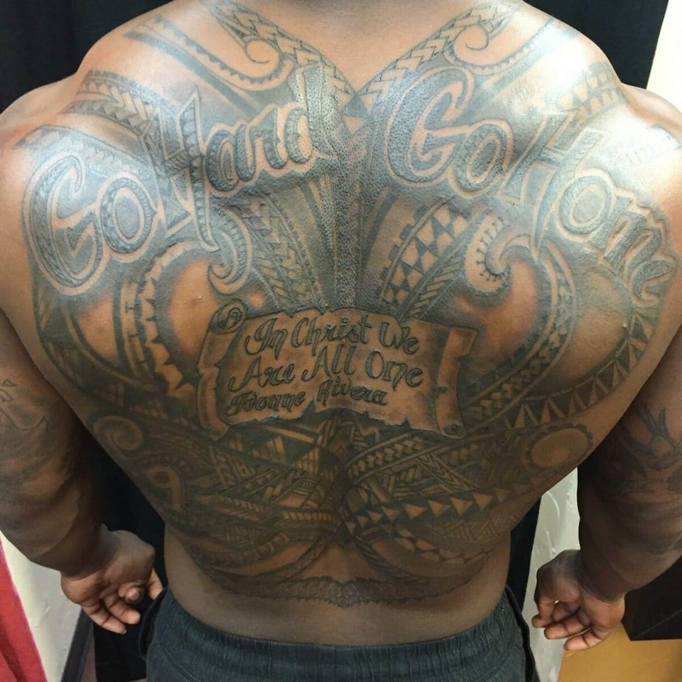 Black Polynesian patterns surround large lettering and a script-filled scroll across the full back.