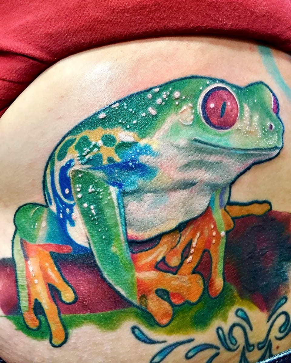 A color realism red-eyed tree frog perched on a branch covers the side of a waist.